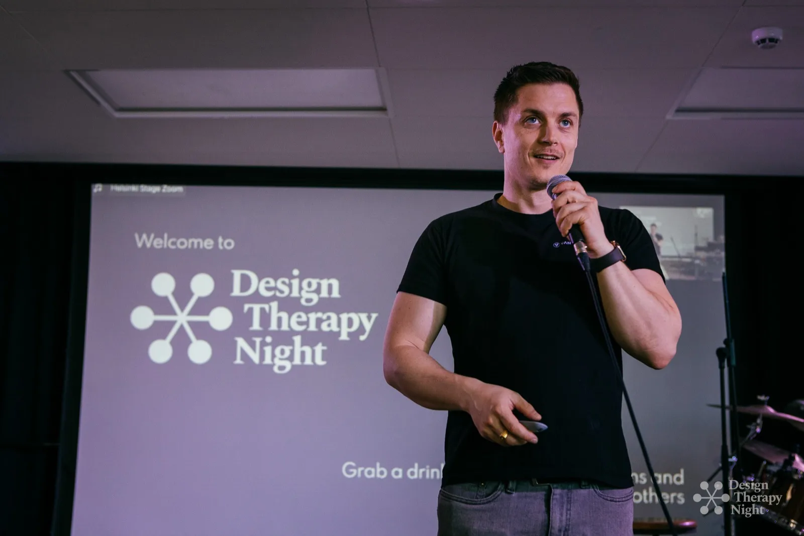 Vitali hosting Design Therapy Night, microphone in hand
