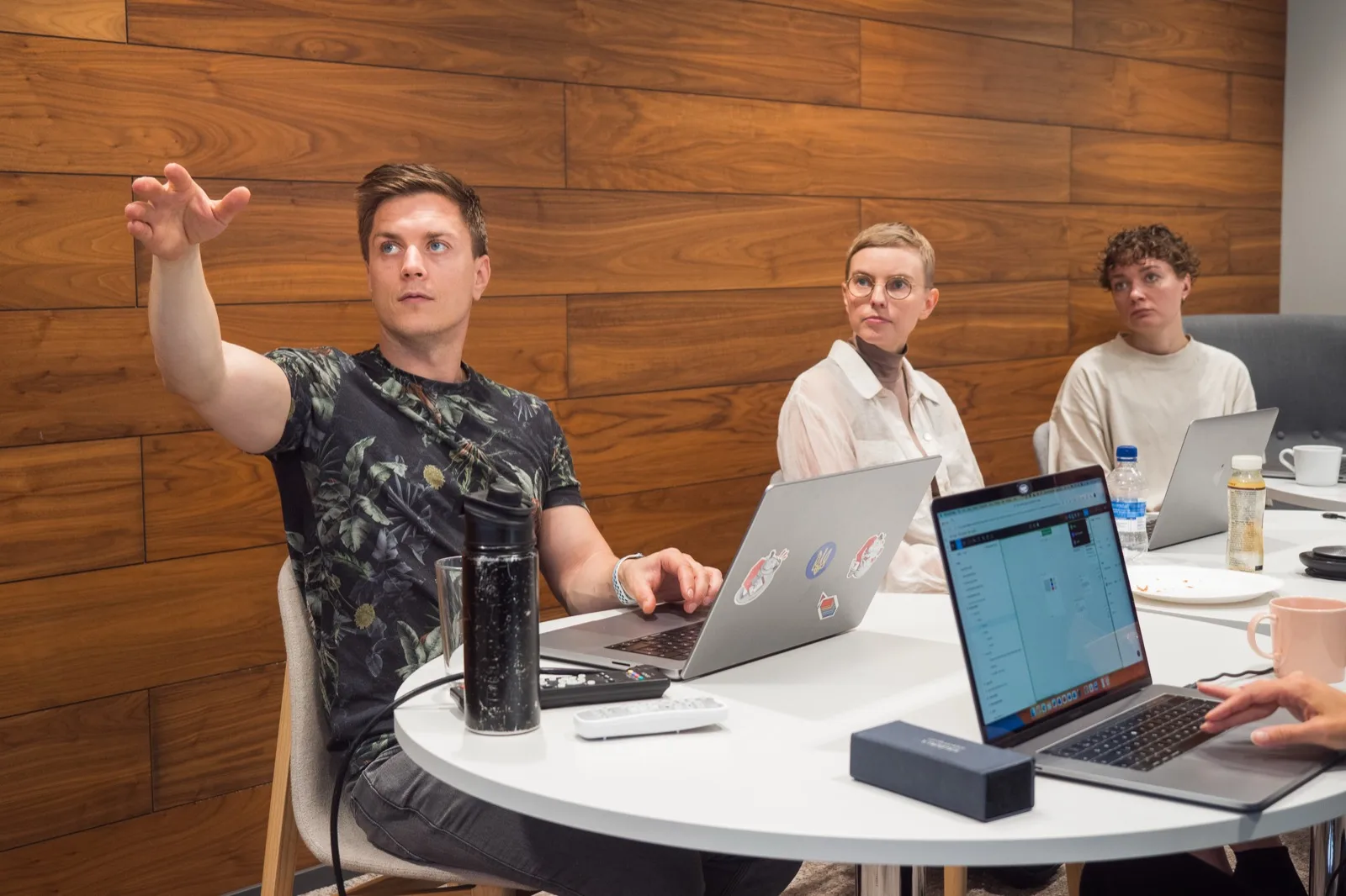 Vitali working through a problem with colleagues at a table, laptops open